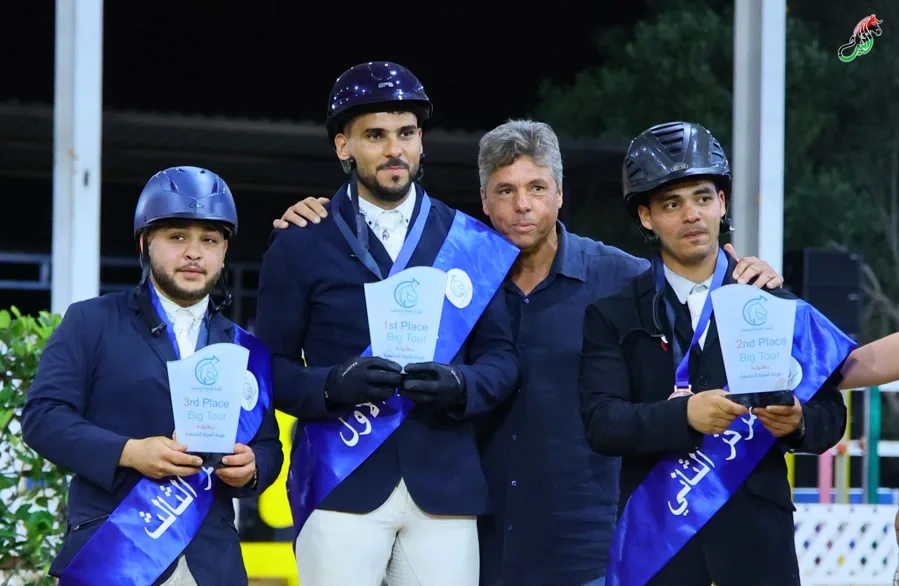 Winning rider holding his trophy on the podium