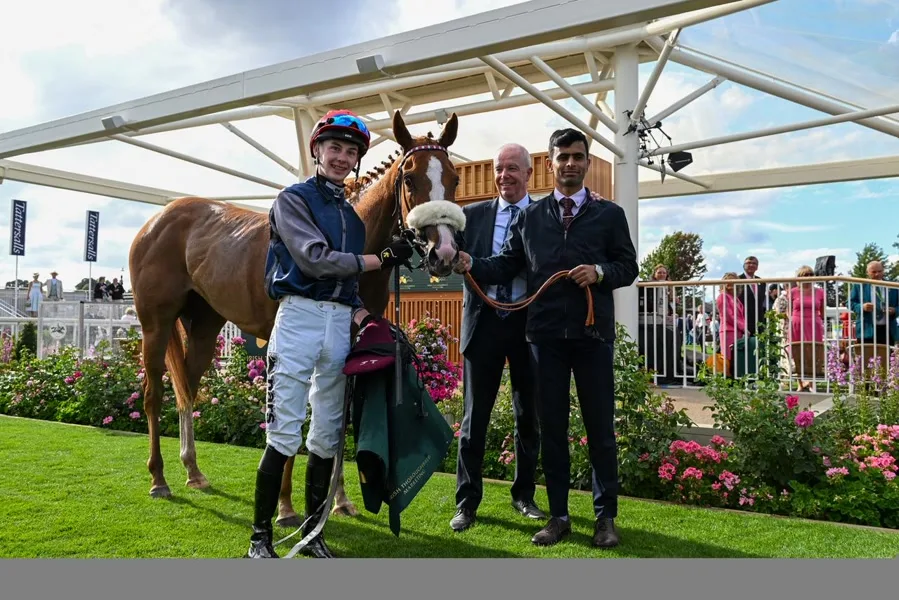 Jockey and chestnut racehorse in the winners enclosure at York